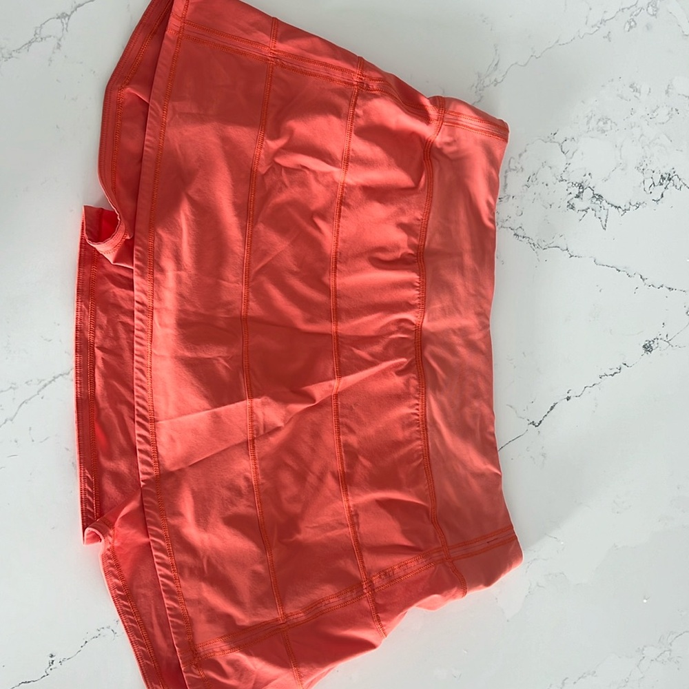 Orange Lulu tennis skirt.  Size 10. Small spot on front.  Shown in picture.